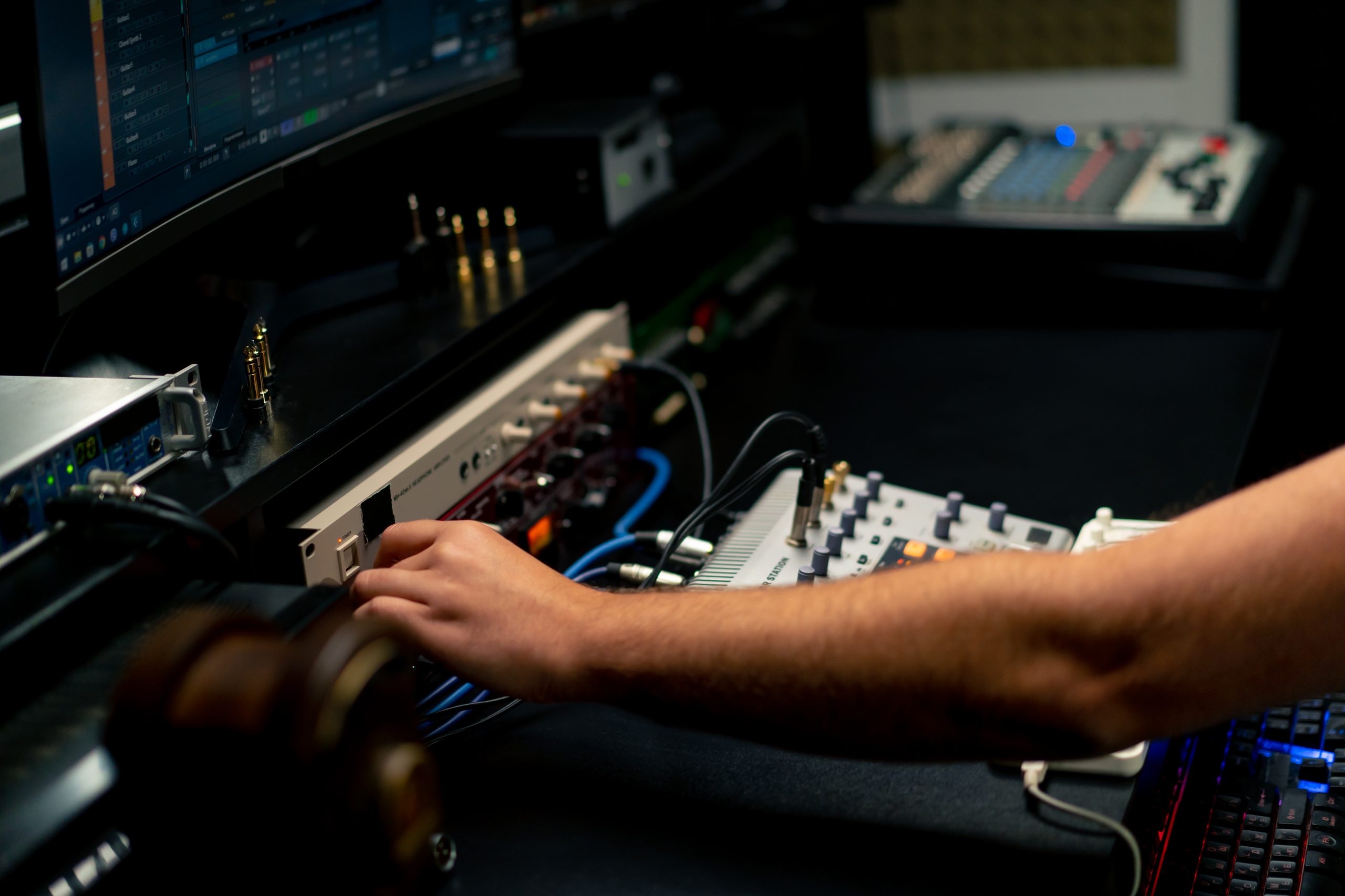 close-up shot of the male hand of a sound engineer switching settings on the mixing console for recording a soundtrack